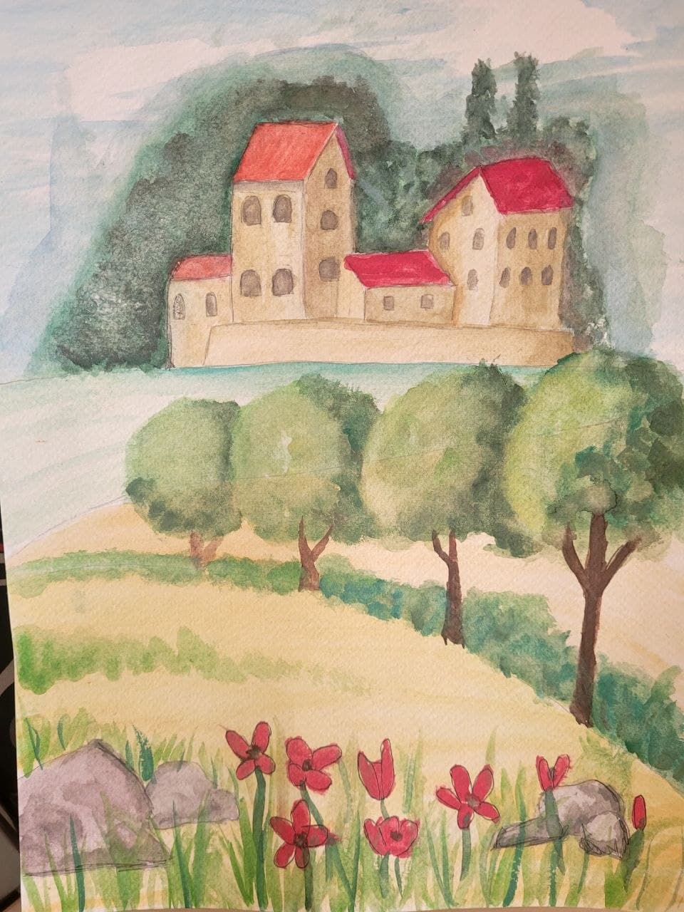Watercolor painting of red-roofed buildings on a hill with green trees and red flowers.